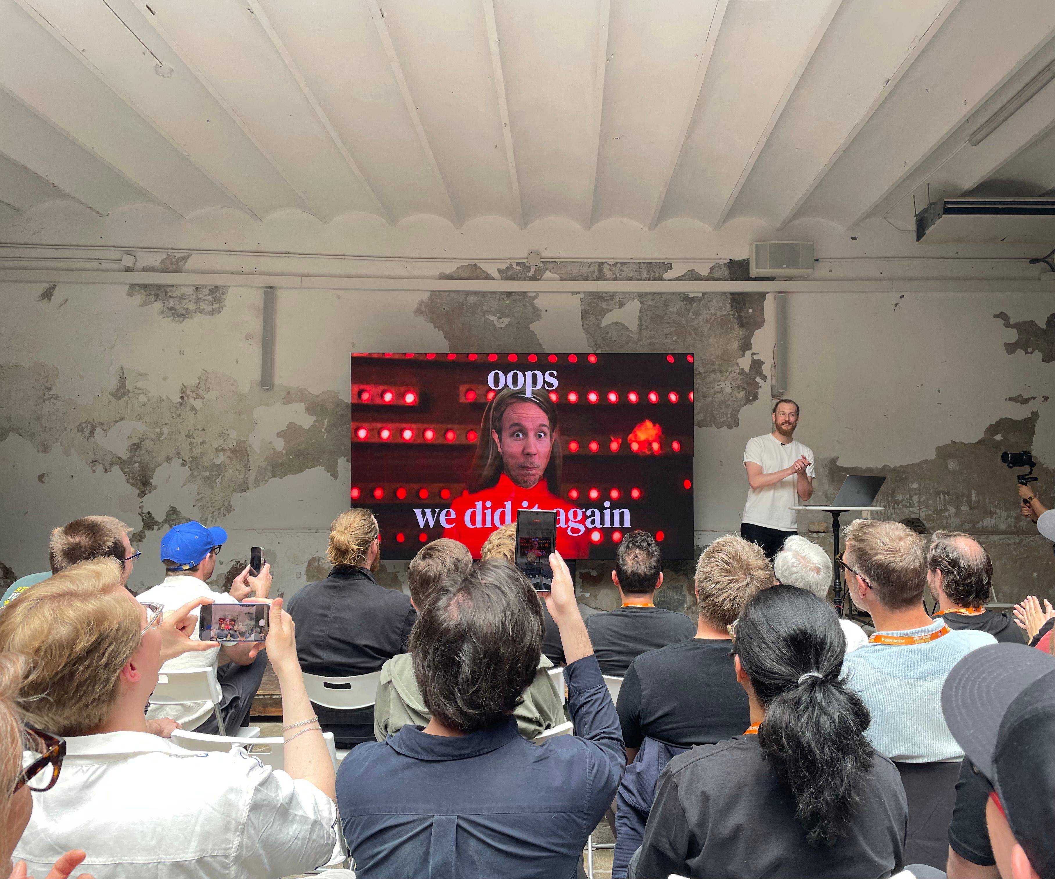 Photo of Rich Harris' talk. The slide shows a meme where Britney Spears has Kevin's head. The slide says: Opps, we did it again.