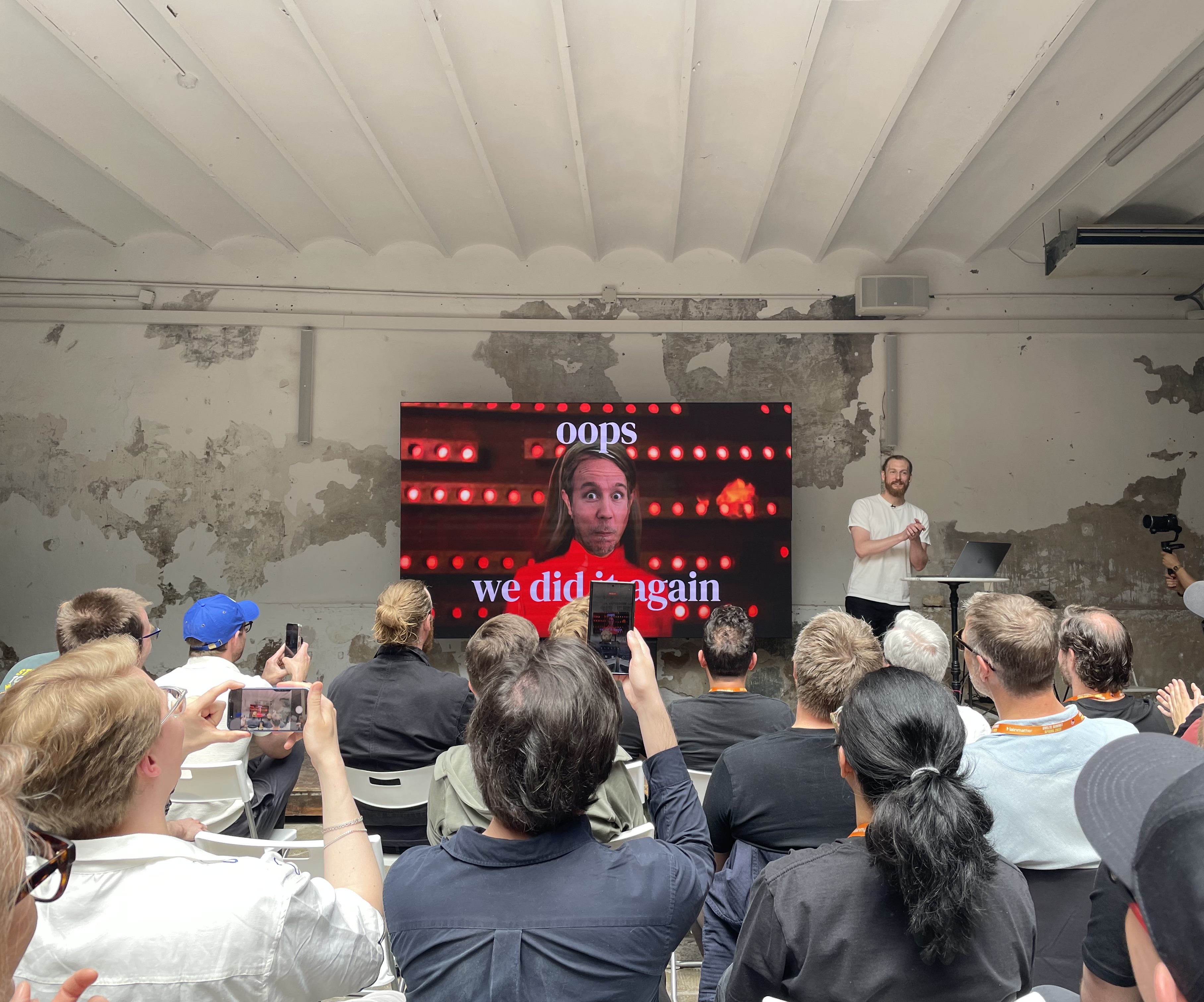 Photo of Rich Harris' talk. The slide shows a meme where Britney Spears has Kevin's head. The slide says: Opps, we did it again.